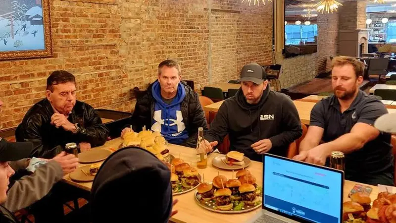 Association members over burgers and a laptop at a Restaurant Week 2025 planning lunch